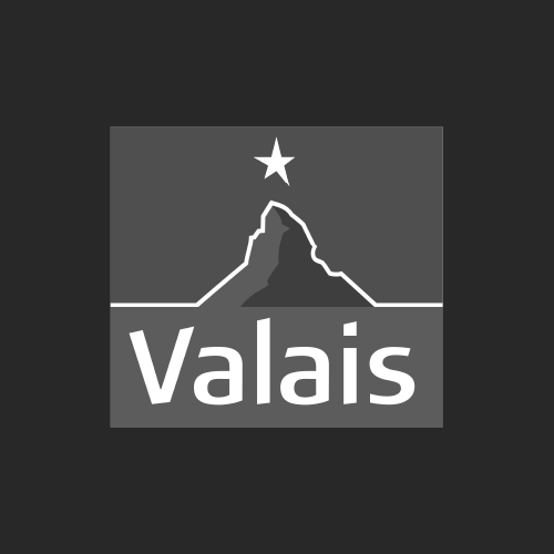 Silhouette de montagne avec une étoile au-dessus du mot « Valais » en blanc sur un fond gris foncé.