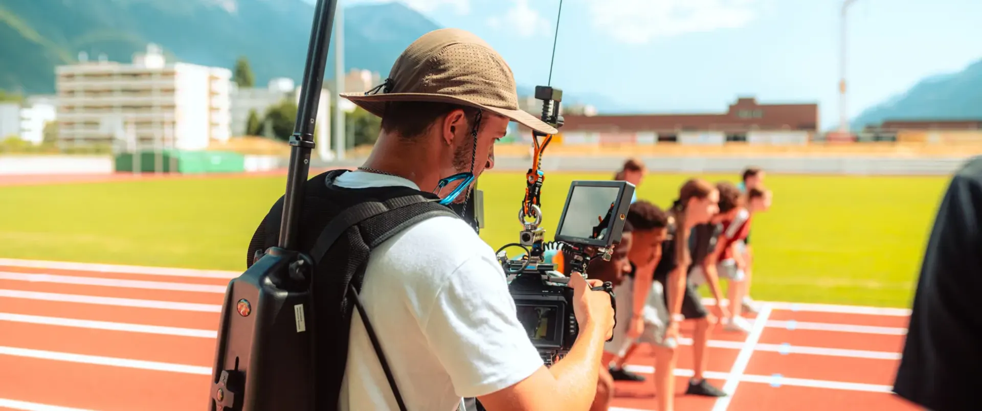 Bruno Perrin, director of photography, filming a commercial on a professional film set in Switzerland with athletes on a running track